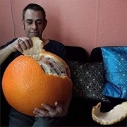 Man Eating Comically Large Orange