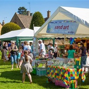 Man a Stall at a Summer Fete