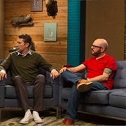 4. David Cross Wears a Red Polo Shirt &amp; Brown Shoes With Red Laces