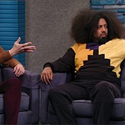 19. Reggie Watts Wears a Purple and Yellow Quilted Sweatshirt