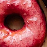 Strawberry Iced and Cream-Filled Chocolate Donut With Crushed Oreos