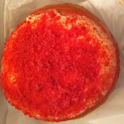 Cinnamon Sugar Red Velvet Round Donut With Caramel Drizzle, and Chocolate Chips