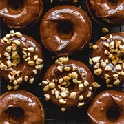 Chocolate Iced and Cookie Dough-Filled Pumpkin Donut With Peanuts