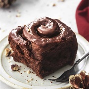 Lemon-Filled Glazed Chocolate Roll Donut With Neapolitan Drizzle and Pistachios