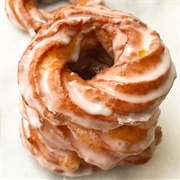 Chocolate Iced Pumpkin Cruller With Orange Drizzle and Marshmallows