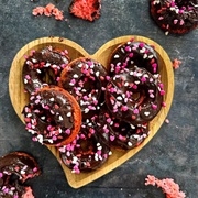 Strawberry Iced and Strawberry-Filled Chocolate Ring Donut With Marshmallows