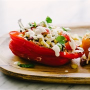 Cheesy Corn, Pepper, Tomato Sauce, and Muffuletta Stuffed Peppers