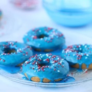 Blue Iced and Cream-Filled Chocolate Round Donut With Sprinkles