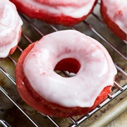 Vanilla Iced and Strawberry-Filled Red Velvet Ring Donut With Blue Drizzle