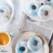 Vanilla Iced and Strawberry Jelly-Filled Donut With Blue Drizzle