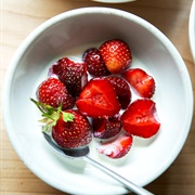 Fresh Strawberries With Sugar and Pouring Cream