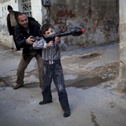 A Man Teaches Bilal, 11, How to Use a Rocket Propelled Grenade in Idlib,... (Rodrigo Abd)